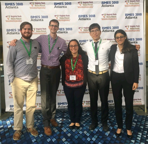 Five students standing in front of a sign that reads 'BMES 2018 Atlanta'