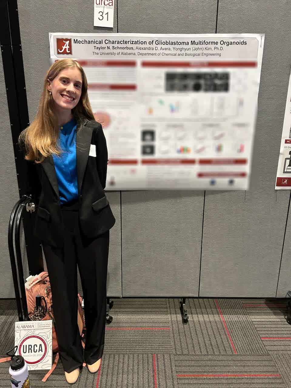 A female student standing in front of a blurred poster