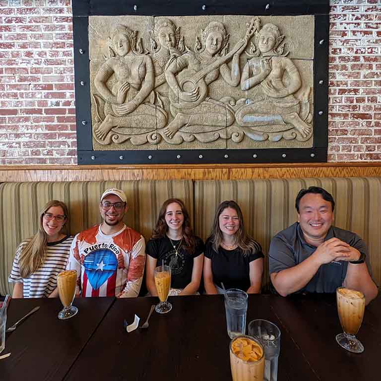 Group of students and professor at a Thai restaurant