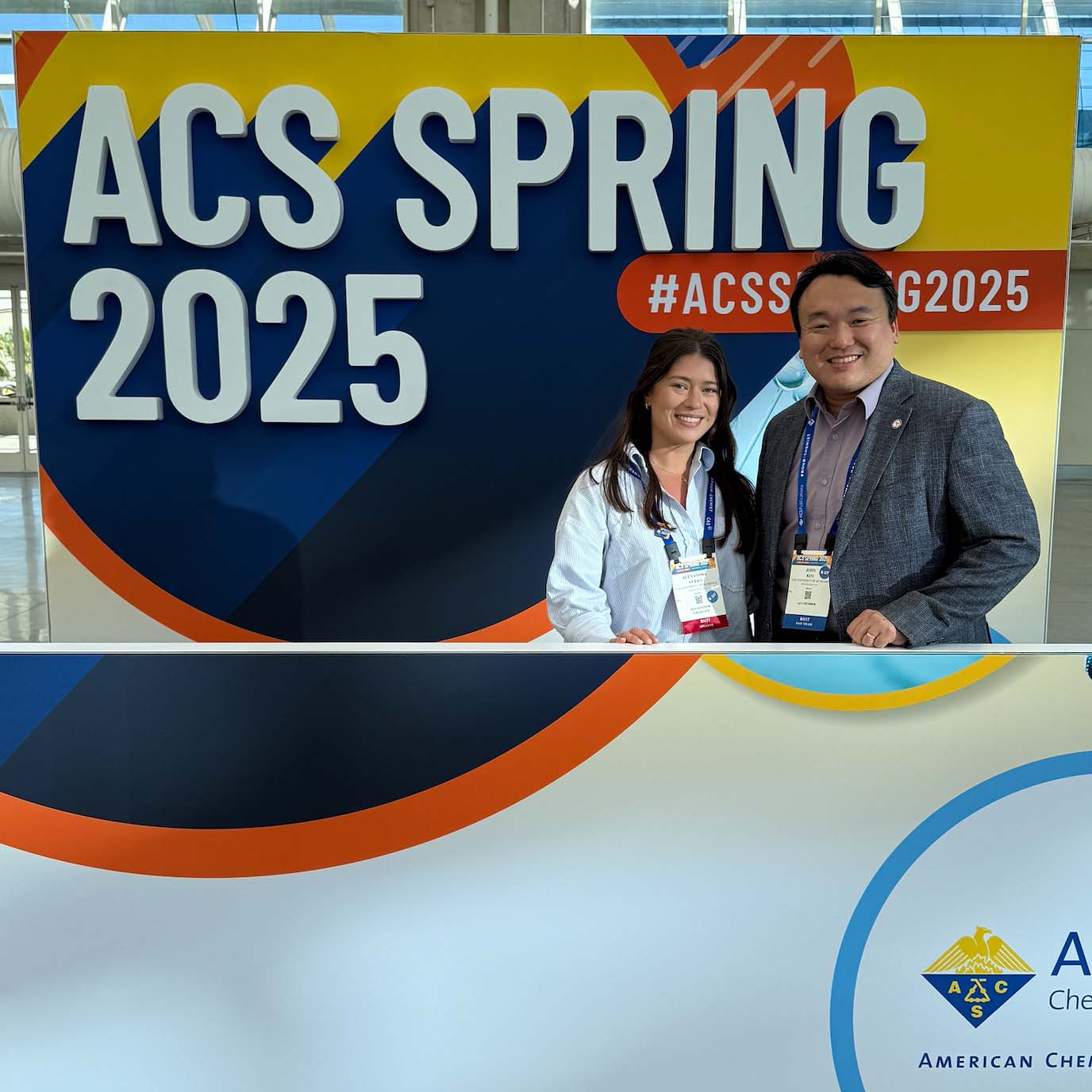 Professor and student in front of the ACS Spring 2025 sign